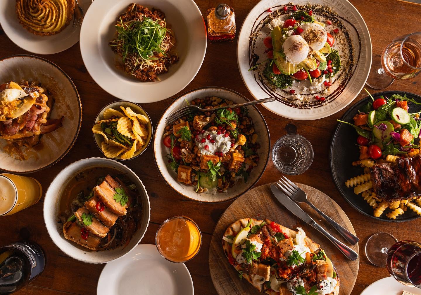A generous spread of Raumati Social Club dishes on a timber table
